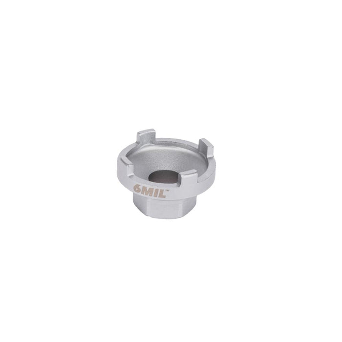 The 6MIL Freewheel Removal Tool (16T) is a silver metallic part made from heat-treated steel, featuring a center hole and four raised notches, designed for BMX freewheel removal, displayed on a plain white background.