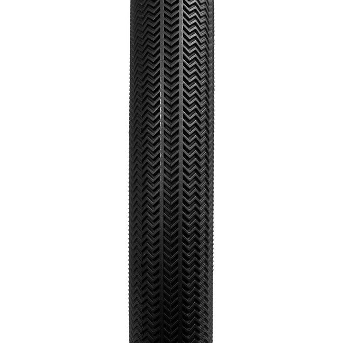 A black Alienation TCS R1 20 Inch Tyre (Tubeless/Foldable) is seen from above, displaying its intricate zigzag tread pattern against a white background, reflecting the high-performance design typical of BMX race tyres.