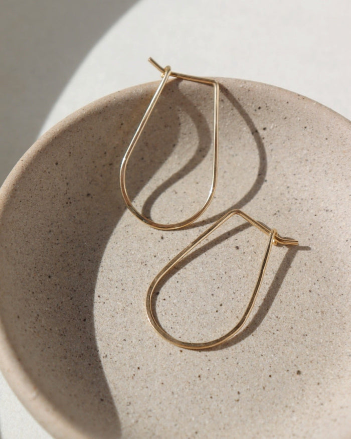 solid gold athena hoops, solid gold hoops, hand hammered solid gold, handmade jewelry, made in the USA, made in wisconsin, woman owned business, classic hoops, classic gold hoops, effortless jewelry, timeless gold jewelry.