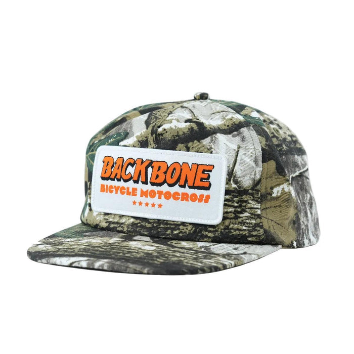 The Backbone 5 Star Snapback Hat is a camouflage-patterned 5 panel cap with a white patch featuring "BACKBONE BICYCLE MOTOCROSS" in orange—an ideal accessory for any Backbone BMX fan.