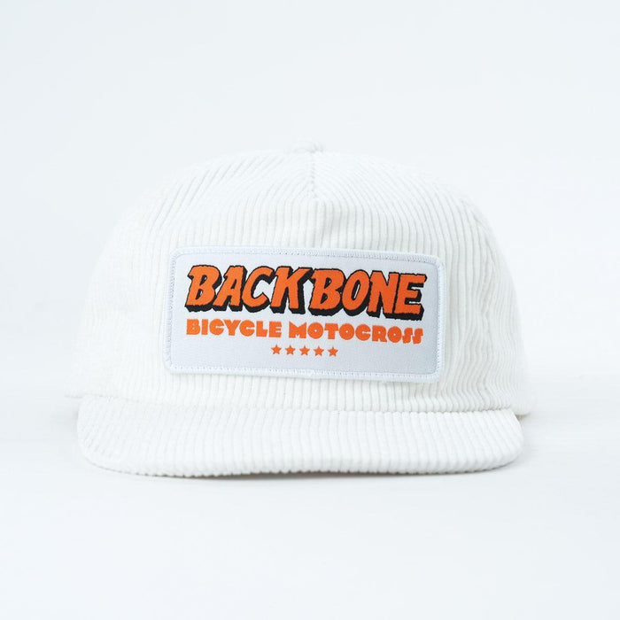 The Backbone 5 Star Snapback Hat is a white corduroy 5-panel cap with a front patch that says "BACKBONE BICYCLE MOTOCROSS" in orange and five small red stars beneath—ideal for any Backbone BMX fan.