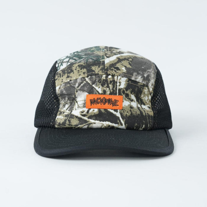 The Backbone Ride Club Hat features a camouflage and black mesh design with an orange "BACKBONE" patch on the front panel, shown against a plain white background.