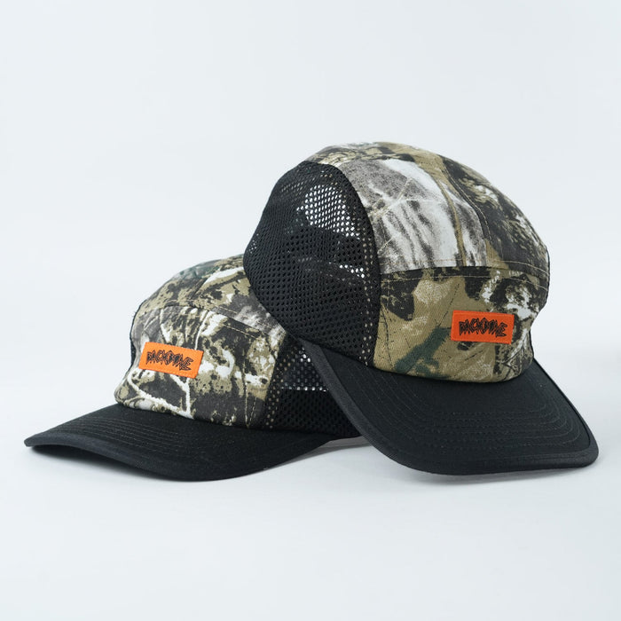 Two Backbone Ride Club Hats featuring a camouflage mesh design, black brims, and orange "INCOME" patches are stacked together against a plain white background.