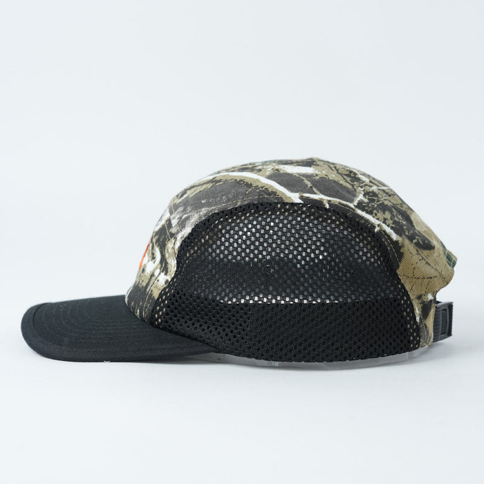 The Backbone Ride Club Hat features a camouflage pattern, black mesh back, and black brim, displayed in profile against a plain white background.