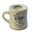 The Backbone Two Tyred Diner Mug is a white ceramic mug with a cartoon face in a cap and bike-shaped glasses, "TWO TYRED FOR EVERYTHING ELSE." text, and "BACKBONE" inside the rim—ideal BMX biker gift.