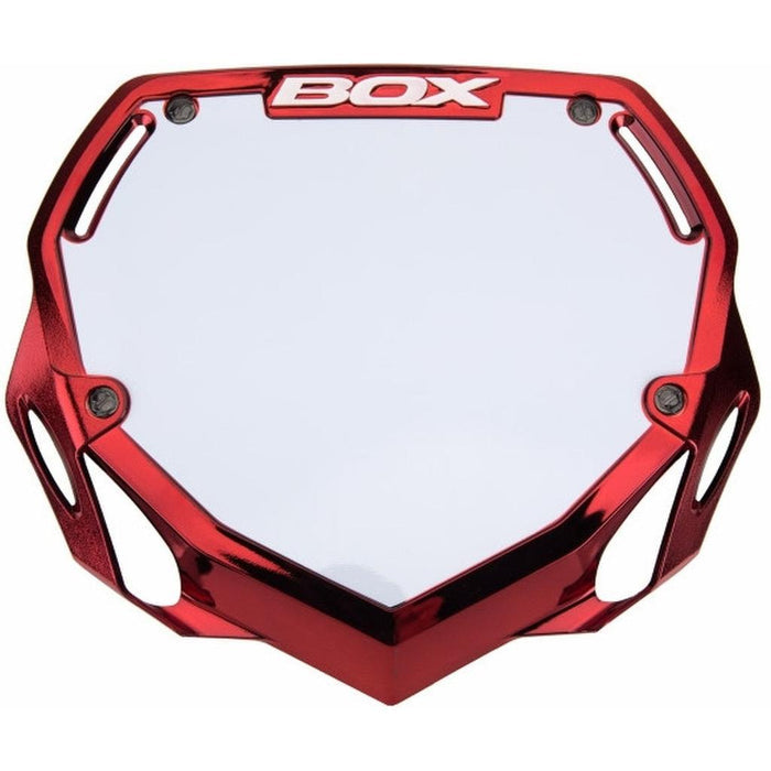 The BOX Phase 1 Number Plate / Small Red Crome is a red and white BMX plate with "BOX" at the top. It features mounting holes at each corner, making it ideal for customizing your ride’s style.
