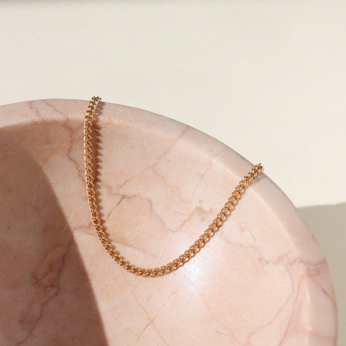 14k gold fill chain bracelet on a light dish