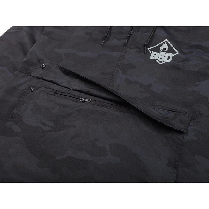 The BSD Roastin Jacket is a black camo design crafted from waterproof nylon. It features a "BSD" logo on the chest, zippered pockets, and a partially visible hood, combining functionality with style.