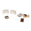 Six small metallic pieces from the BSD Swerve Pawl/Spring Set, featuring textured silver and smooth bronze parts, are arranged on a white surface.