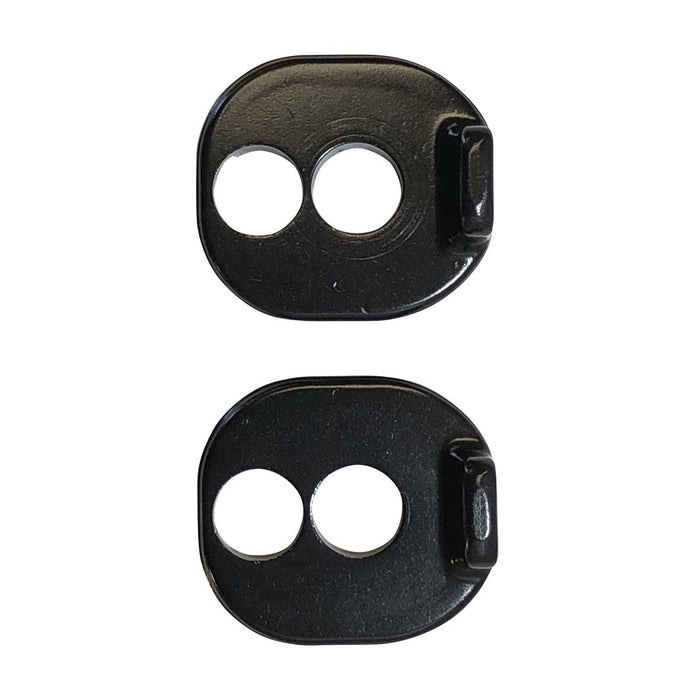 Two black Chain Tensioner Kit for ACT Frame metal plates, each featuring two circular holes and a raised edge on one side, are displayed vertically against a white background. These blocks are compatible with ACT 1.2 frames and come in either 10mm or 20mm sizes.