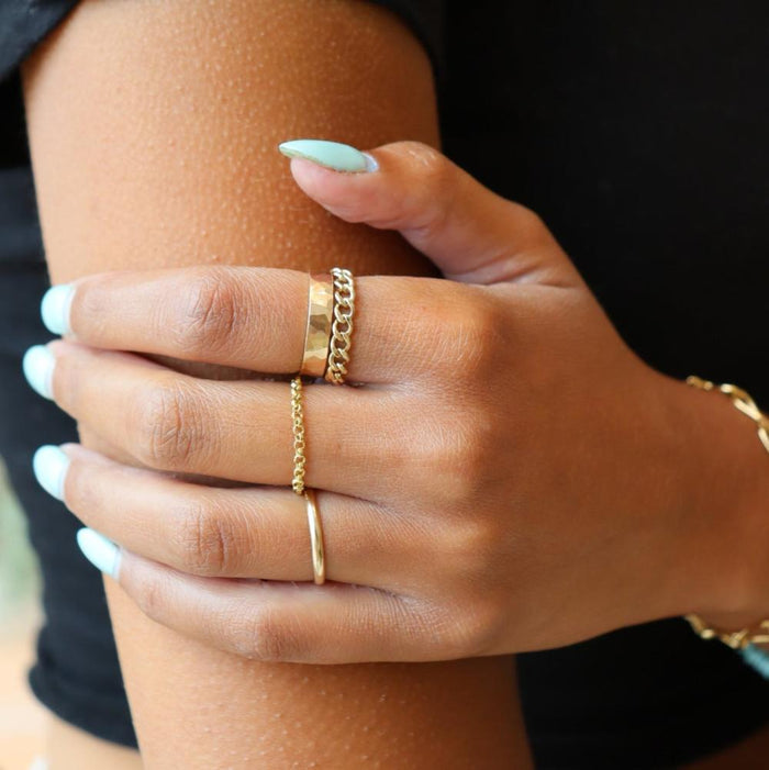 Model wearing 14k gold fill hammered band ring with chain rings