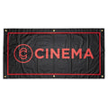 The Cinema Hanging Wall Banner features heavy-duty vinyl, a black background with red border, bold "CINEMA" lettering, and a circular logo on the left. Four metal grommets in the corners make it perfect for stylish room decor.