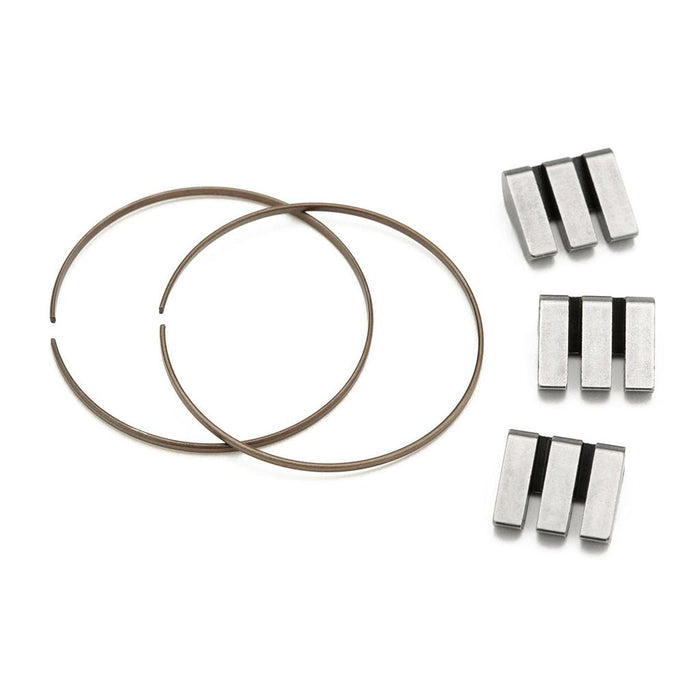 Two metal circlips and six rectangular metal parts with black grooves are arranged on a white background, forming the Cinema ZX Rear Hub Pawl Kit—ideal as replacement parts for your ZX rear wheel or cassette hub.
