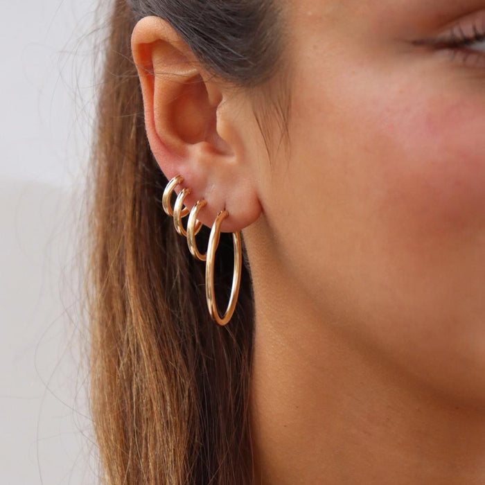 model wearing gold fill mini classic hoop, gold fill small classic hoop, gold fill medium classic hoop, gold fill large classic hoop
