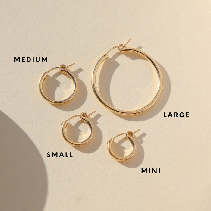 graphic displaying gold fill mini classic hoop, gold fill small classic hoop, gold fill medium classic hoop, gold fill large classic hoop in the sun