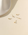 gold fill classic studs laid in the sun
