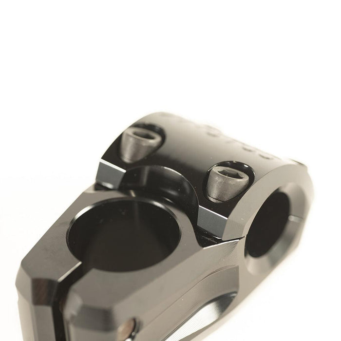 Close-up of a black metal BMX stem component, specifically the Colony Variant 35mm Stem (22.2mm Clamp), featuring visible bolts and circular openings, photographed on a white background.
