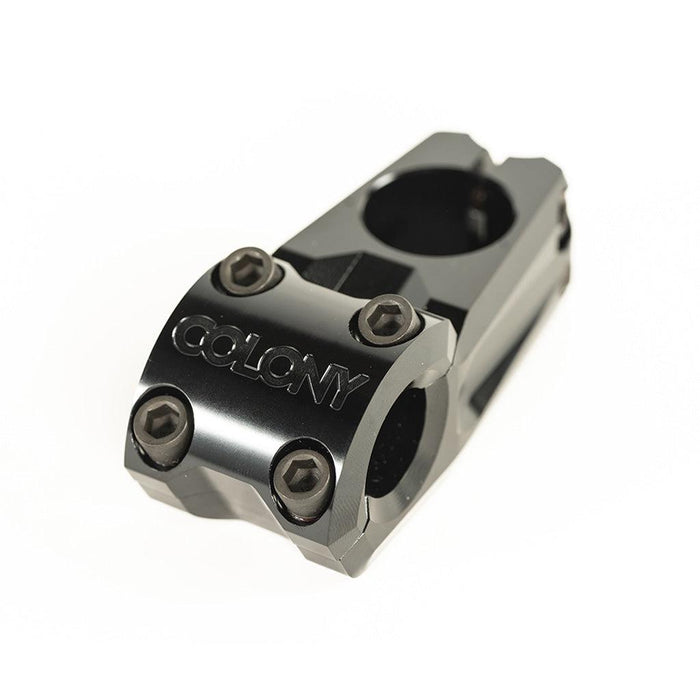 A black metal Colony Variant 52mm BMX Stem (22.2mm Clamp) with “COLONY” embossed on the front and five visible bolts, this sleek low-rise stem is displayed against a plain white background.