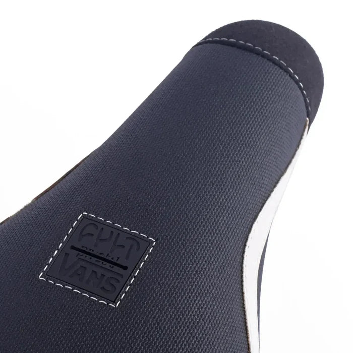 Close-up of the Cult Vans Pivotal Old Skool Pivotal Seat in Black/White, showcasing white stitching and a square "CULT x VANS" logo patch.