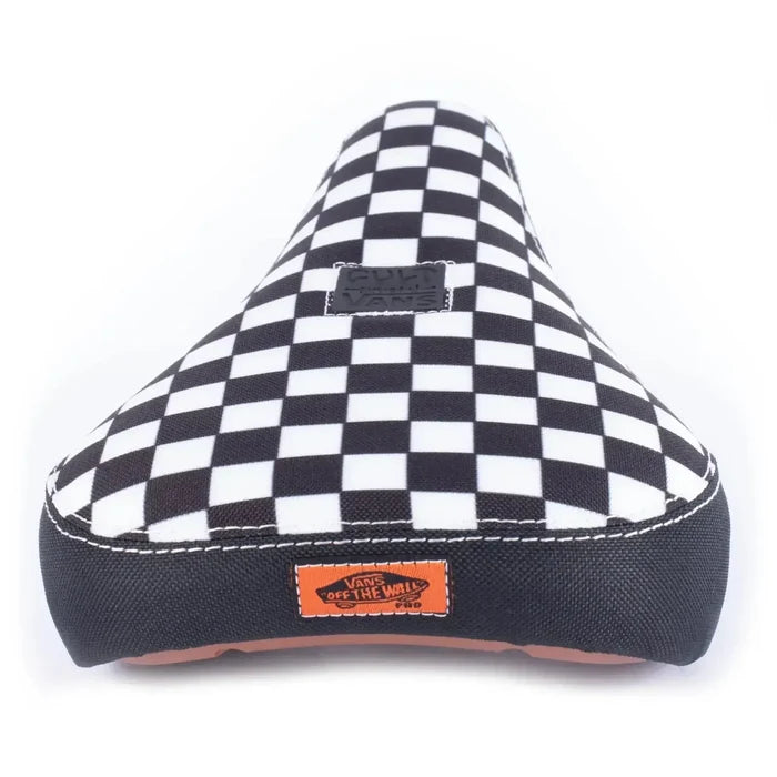 The Cult X Vans Slip On Checker Seat is a limited edition BMX seat featuring a black and white checkerboard pattern, "Vans" logo patch on top, and an orange "Vans Off The Wall" label for iconic style.