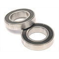Two Eclat Pulse Hub Bearing Set (Front) metal ball bearings with black seals are shown on a white surface, partially overlapping—perfect for front hub replacements.