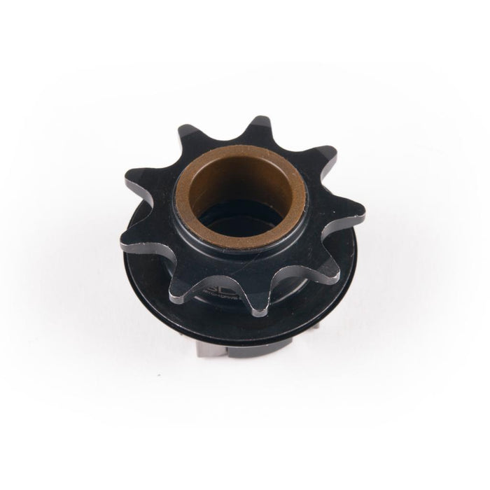 A black metal Eclat Pulse Hub Driver with nine teeth and a brass-colored center bore, photographed on a white background—perfect as a replacement part for your Eclat Pulse hub.