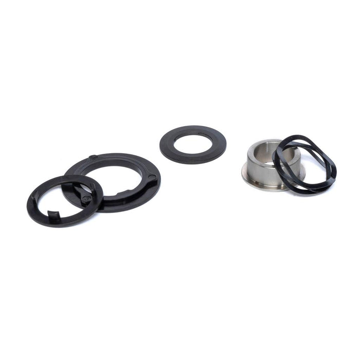The Eclat Shift/WTP Hybrid Slack Disc Set, featuring black plastic rings, a metal cylinder, and rubber gaskets—perfect for Eclat Shift or WTP Hybrid hub setups—is arranged on a white background.