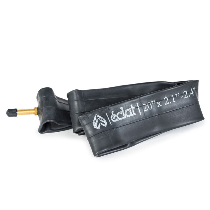 A rolled-up black Eclat Solo SV Inner Tube with a sturdy brass Schrader valve, labeled “éclat 20” x 2.1”–2.4”, perfect as a reliable 20″ bike tube for your ride.