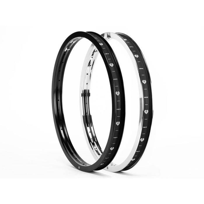 Two Eclat Temple 20 Inch Rims—one black, one silver—stand upright side by side on a white background, featuring 6061-T6 alloy and lightweight double-wall construction with heart-shaped markings around their circumference.