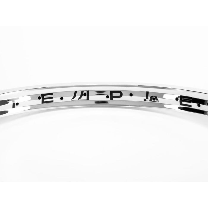 Close-up of the Eclat Temple 20 Inch Rim's lightweight double-wall metallic surface, featuring evenly spaced black geometric and abstract symbols along its inner edge.