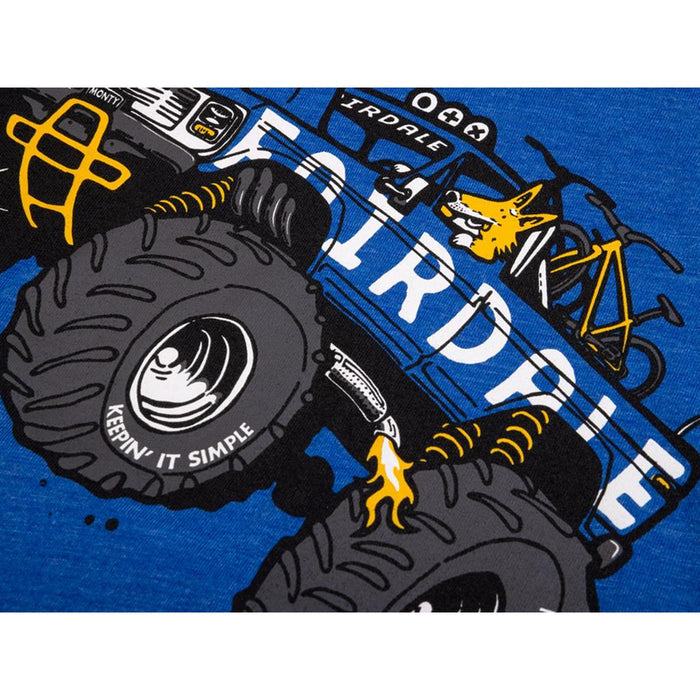 Illustration of the Fairdale Monty Truck with a fox driving, printed on blue fabric. Perfect for truck-themed kids' shirts, the design has big tires and "KEEPIN' IT SIMPLE" on one wheel.