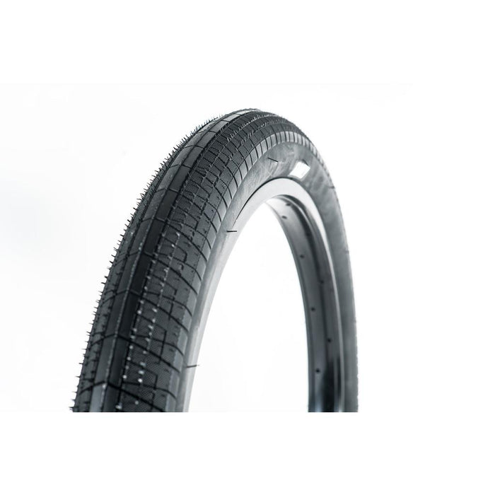 A close-up of the Family BMX F603 18 Inch Tyre in black, showcasing its versatile tread pattern against a white background.