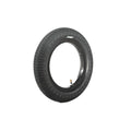 The Family F641 12 Inch Tyre, made of black rubber with a knurled tread and visible air valve, stands upright on a white background.