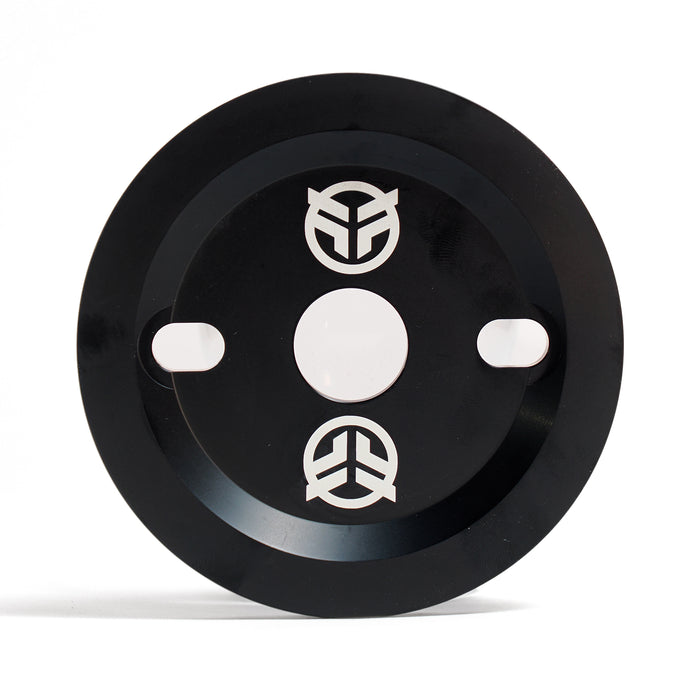 The Federal Code Guard Sprocket is a black circular metal sprocket with two oval slots, a central hole, and three white abstract Federal logos—designed for BMX enthusiasts.