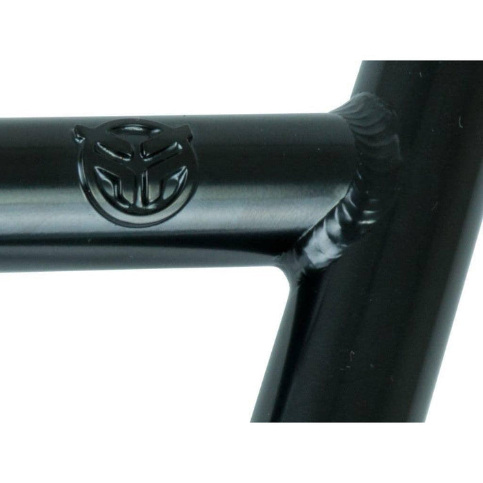 Close-up of a black metal frame with the Federal logo embossed on it, highlighting a welded joint connecting two cylindrical, heat-treated tubes—perfectly suited for the 22.2mm clamp size of the Federal Lacey Bars, ideal for 20 inch BMX setups.
