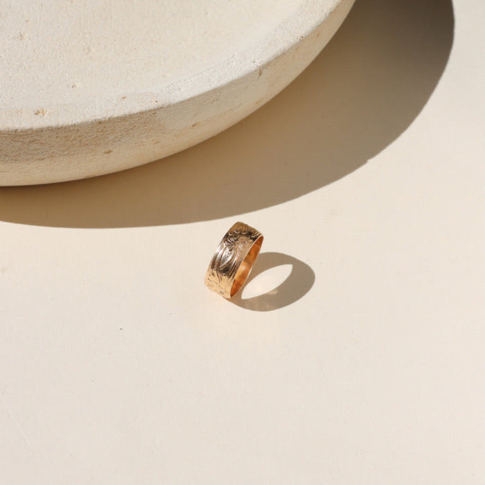 14k gold fill textured ring on a light surface