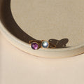 2 14k gold fill rings with round fluorite stones on a light dish