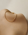 14k gold fill chain bracelet on a light dish
