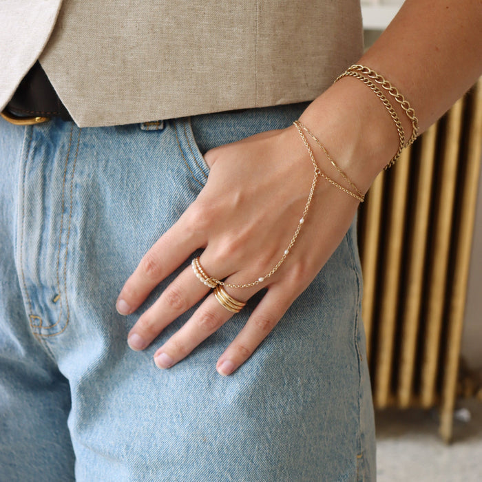 model wearing 14k gold fill hand chain with pearls