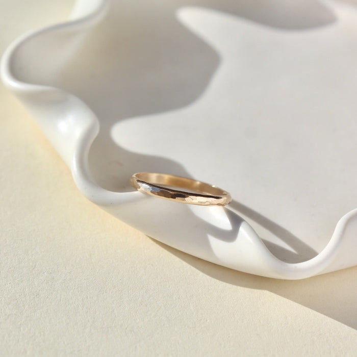 lightly textured 14k solid gold circle ring in the sunlight
