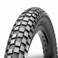 Close-up of a HOLY ROLLER 26" Wire Bead tyre with a knobby tread pattern, designed for off-road or dirt jump use, set against a plain white background.
