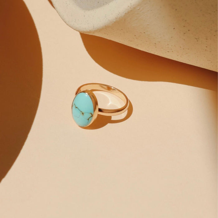 14k gold fill ring with oval turquoise gemstone in the sunlight