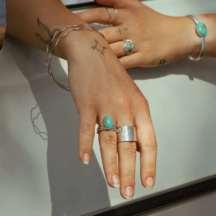 model wearing sterling silver jewelry with turquoise accents