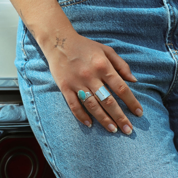model wearing sterling silver rings with turquoise stone