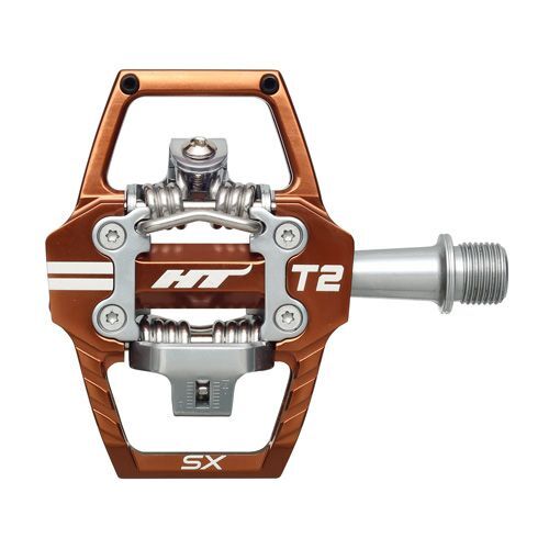 The HT T2-SX Clip In Pedals feature a metallic orange frame, CNC machined chromoly spindle, and clipless mechanism for cycling shoes—ideal for mountain biking.
