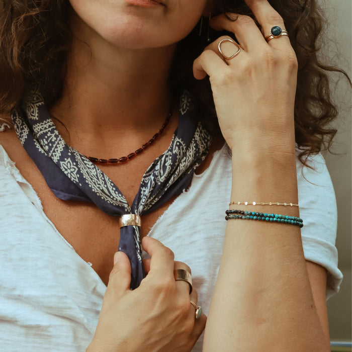 model wearing 14k gold fill jewelry with gemstones