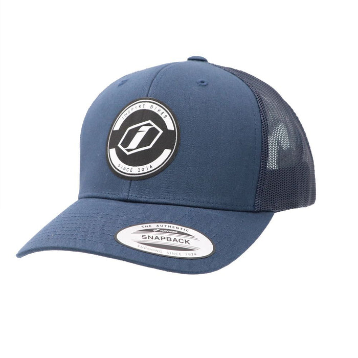 The Inspyre Trucker Cap is a blue snapback with a mesh back and a front patch reading "Update Bikes Since 2016," ideal for fans of Inspyre Bicycles.