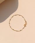 Labradorite Gemlink Bracelet with iridescent labradorite gemstones and delicate gold-filled links on a warm cream background.