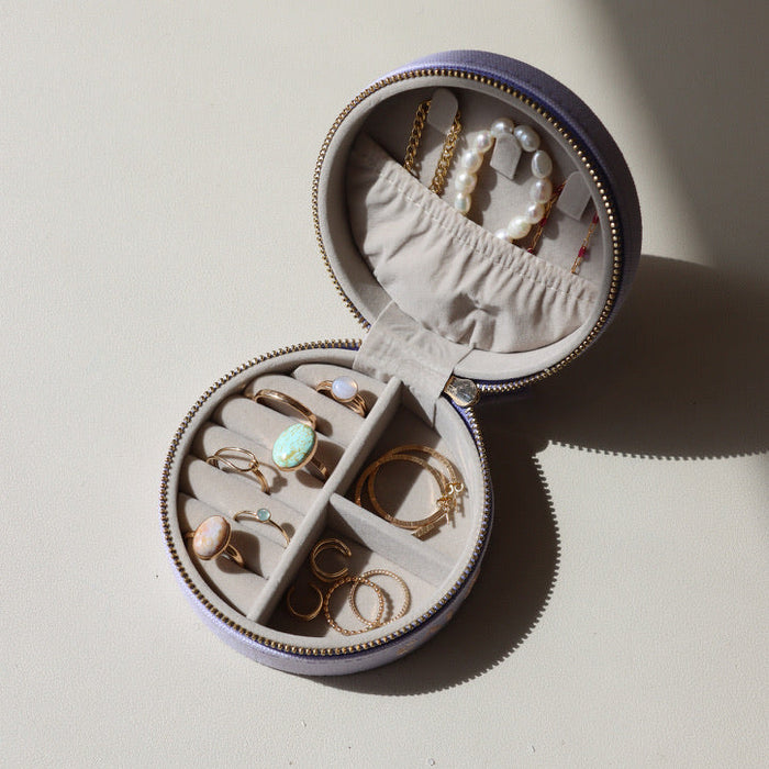 large lavender jewelry travel case opened with various 14k gold fill and gemstone jewelry