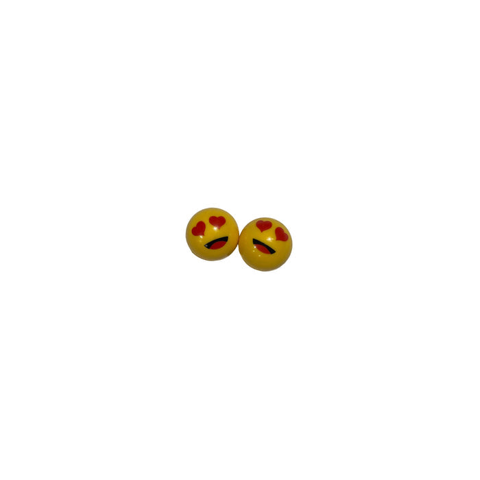 Lovey Dovey Schrader Valve Caps (Pair): Round yellow caps with heart-shaped eyes and a curved black mouth, perfect for adding fun flair to your BMX or showing your love for cycling.
